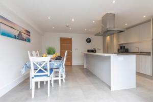 a kitchen with a table and chairs in a room at Modern & Spacious Home in Central Cheltenham in Gloucestershire