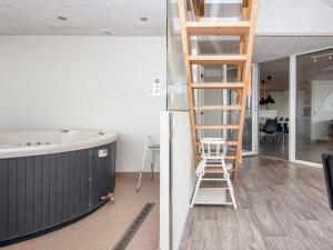 a room with a ladder next to a bath tub at 12 person holiday home in Harboøre-By Traum in Harboør