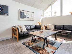 a living room with a table and a couch at 12 person holiday home in Harboøre-By Traum in Harboør