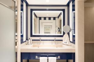 a bathroom with a sink and a mirror at Hotel Mim Sotogrande in Sotogrande +93 photos