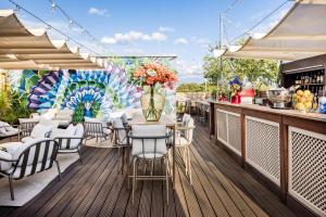 a patio with a table and chairs and a mural at Hotel AMANO Rooms & Apartments in Berlin
