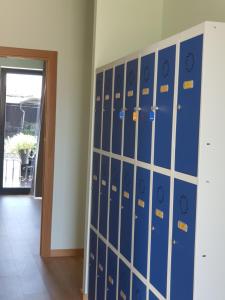 a locker room with blue lockers at Alvorada Medieval, AL in Valença