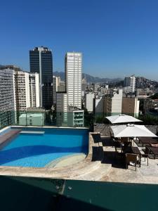 a swimming pool with a view of a city at Casa Mauá 1407 in Rio de Janeiro