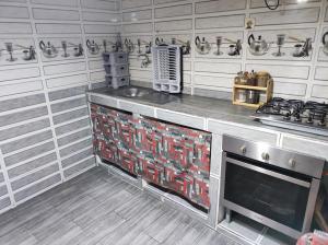 a kitchen with a stove and a counter top at Riad Bennouna in Fez