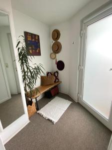 a room with a door and a plant and a mirror at Lichtblick in Radebeul
