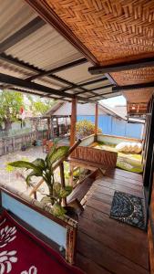 an outdoor deck with a bench and a hot tub at Davi homestay in Sumbawa Besar
