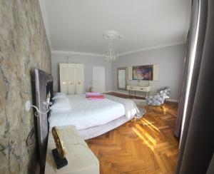 a bedroom with a large white bed and a desk at FLH - Fancy Flats near Big Square in Sibiu
