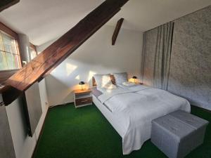 a bedroom with a white bed and green carpet at Villa Alpine Spirit in Gösing an der Mariazeller Bahn