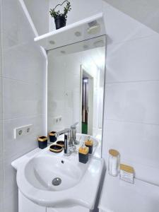 a white bathroom with a sink and a mirror at Villa Alpine Spirit in Gösing an der Mariazeller Bahn +67 photos