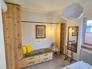 a bedroom with a large wooden bunk bed with yellow pillows at Lago Lodge Claudia in Domaso