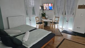 a bedroom with a bed and a table and chairs at Fewo Schwäbische Eisenbahn in Meckenbeuren
