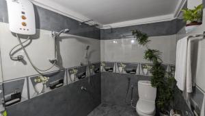 a bathroom with a shower and a toilet with plants at MPS Paradise villa in Tangalle