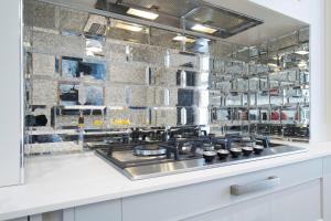 a kitchen with a sink and a stove at Stunning 5 Bed Regency Home in Gloucestershire