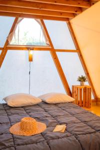 a bed in a room with a large window at Glamping Urrugne in Urrugne