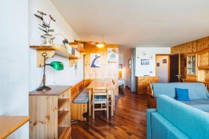a living room with a blue couch and a table at Pila 63 in Pila