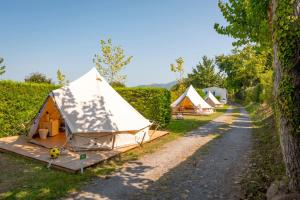 a row of tents parked next to a dirt road at Glamping Urrugne in Urrugne +27 photos