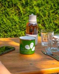 a table with a container of sunbury at Glamping Urrugne in Urrugne