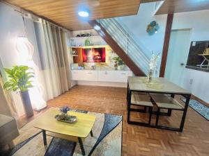 a living room with two tables and a couch at Bloomstone Urban Chill Cabin in Dulongabong