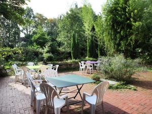 a group of tables and chairs sitting on a brick patio at Spacious 11-Bed Family Retreat in Wijtstraat