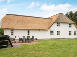 a large white building with a thatched roof at 5 star holiday home in Gram in Gram +37 photos