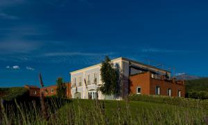 a building on top of a hill next to a building at Villa Neri Resort & Spa in Linguaglossa