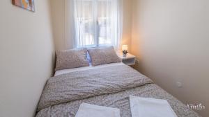 a bed in a small room with a window at Holiday Home Leo in Mostar +39 photos