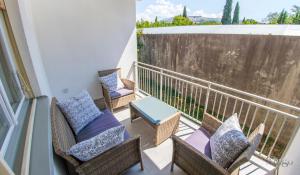a balcony with chairs and a table on a balcony at Holiday Home Leo in Mostar