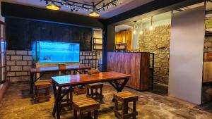 a dining room with a table and a tv at Carls' Corner in Kandy