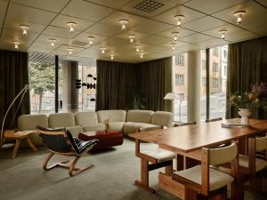 a room with a table and chairs and a couch at Bob W Stockholm Norrmalm in Stockholm