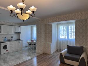Una sala de estar con una silla y una mesa. en Luxury Sea View apartment by Bakuapart, en Baku