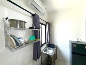 a small kitchen with a sink and a shelf at Patong Canal Villa 102 in Patong Beach