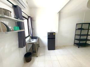 a small kitchen with a sink and a refrigerator at Patong Canal Villa 102 in Patong Beach +8 photos