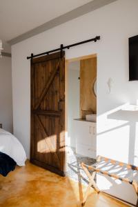 a sliding barn door in a room with a bed at Goedehoop Boutique Apartment in Robertson +24 photos