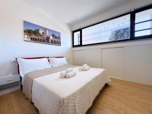 a bedroom with a bed with two towels on it at Maestrale - Elegant Apartment in Udine