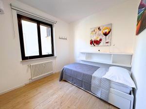 a bedroom with a bed and a window at Maestrale - Elegant Apartment in Udine +6 photos