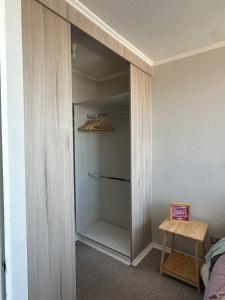 a walk in closet with a wooden table in it at Central apartment CCP in Concepción +3 photos