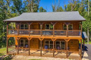 a log cabin with a wrap around deck at Lux Cabin Mtn Views, Flat Parking, Dog Friendly! in Gatlinburg