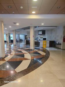 an empty lobby with a checkered floor in a building at vacation720 in Benalmádena