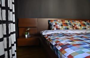 a bedroom with a bed with a colorful comforter at Grandmas Mansion 3BD Meteora - Rocks View in Kalabaka