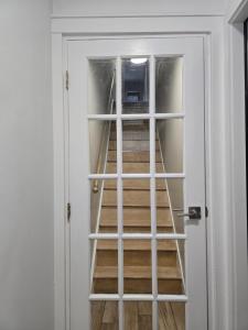 a door with a ladder leading up to a staircase at Astoria, steps away from Manhattan in Astoria