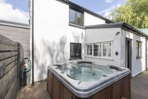 a hot tub in the backyard of a house at Tranquil Cottage with Hot Tub in Skenfrith