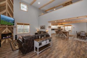 a living room with a couch and a fireplace at Boone Getaway Dog Friendly, Hot Tub, Fire Pit! in Stony Fork