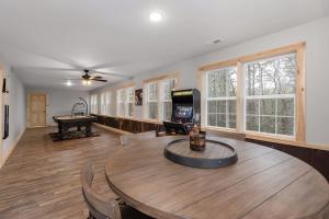 a living room with a table and a pool table at Boone Getaway Dog Friendly, Hot Tub, Fire Pit! in Stony Fork
