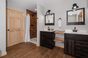 a bathroom with two sinks and a shower at Boone Getaway Dog Friendly, Hot Tub, Fire Pit! in Stony Fork +52 photos
