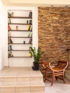 a room with a chair and a brick wall at Villa Kamaritis, Private Suite pool view in Kamára