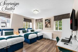 a bedroom with two beds and a desk with a computer at 2 Bedroom Apartment By Sovereign Suites Short Lets & Serviced Accommodation in Brighton in Brighton & Hove