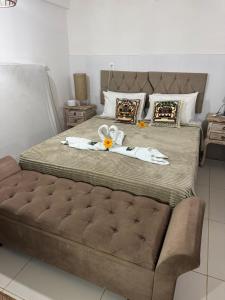 a bedroom with a large bed with towels on it at Apto Gostoso andar Cantina in São Miguel do Gostoso +78 photos