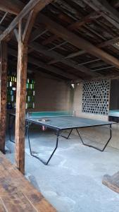 a ping pong table sitting inside of a building at The Black Sheep Inn in Chugchilán