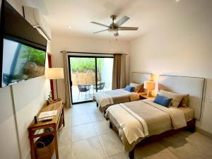 a hotel room with two beds and a balcony at Casa del Mar - Luxury Seaside Villa in Boca de la Vinorama +93 photos
