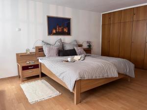a bedroom with a large bed with a night stand at Ferienwohnung am Reichenbach in Hechingen